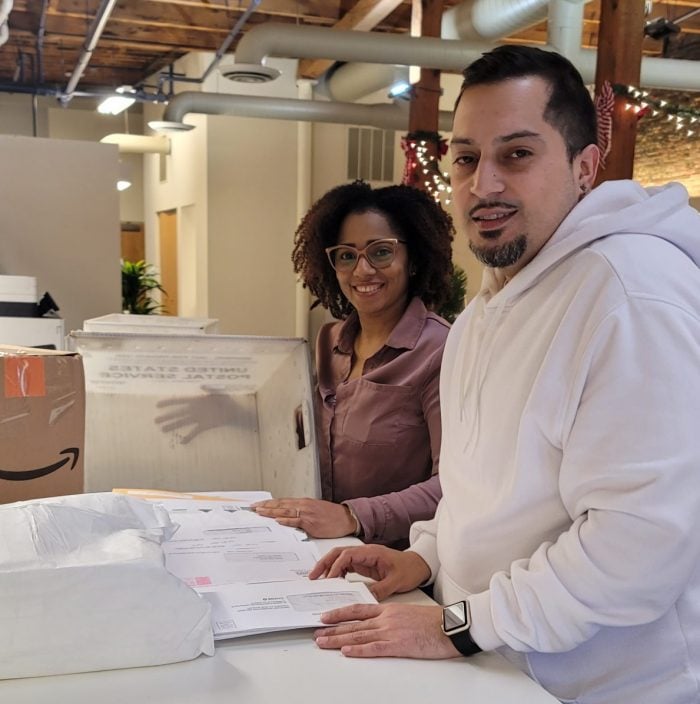 Two registered agents sort mail at the New York Registered Agent office